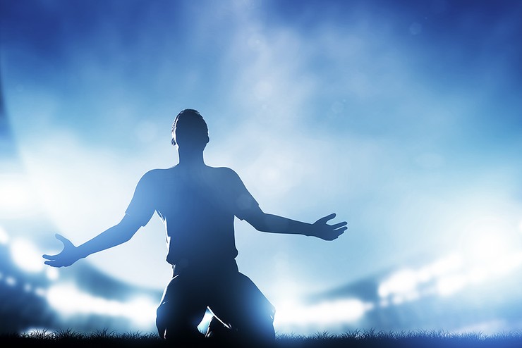 Silhouette of Footballer Celebrating in Stadium